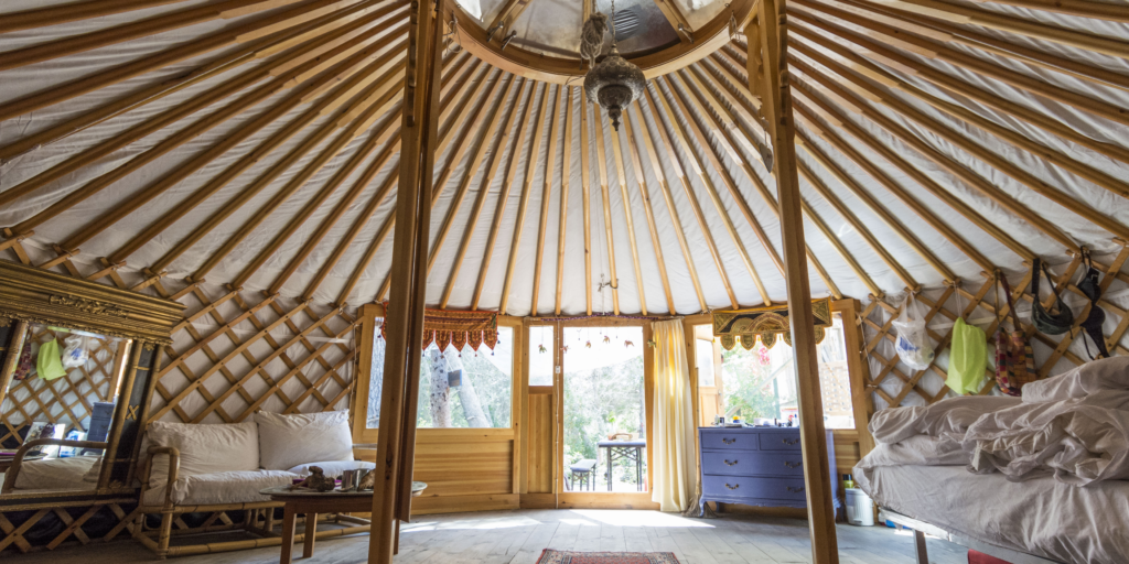 The interior of a furnished yurt home.